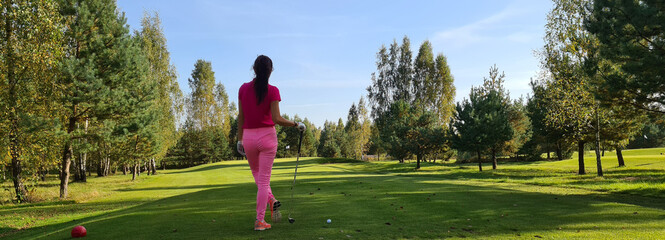Female golfer plays golf on the course
