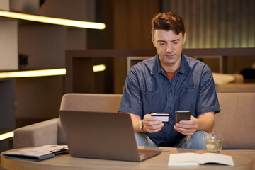 Portrait of entrepreneur transferring money to employee via smartphone app