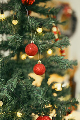 Glitter ornaments and lights on Christmas tree branch decorated. Christmas holiday and New Year concept