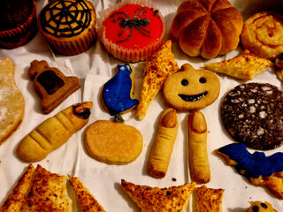 Halloween cookies. meaty parks wrapped in dough resemble a mummy. they also have a spice face....