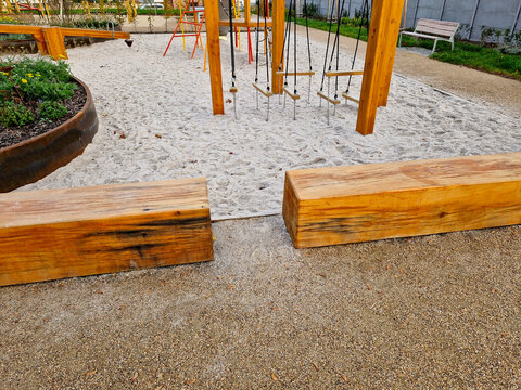 a play element in the park on the children's playground in the form of a suspended ladder low above the sandbox. Balance development training for small and adult children. climbing Center, black