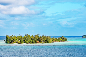 A small motu or islet on the coral reef just off the island of Bora Bora in French Polynesia.