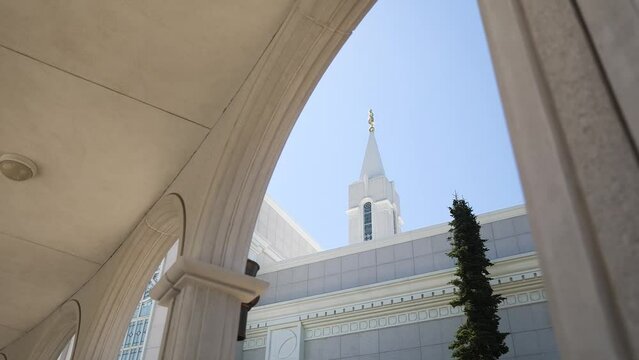 Wide shot under Bountiful Utah Temple arch with angel Moroni statue atop