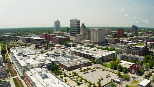 An orbiting drone shot of the Winston-Salem skyline in North Carolina in the summer.