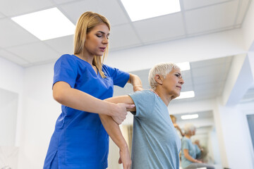 Fototapeta premium Doctor or Physiotherapist working examining treating injured arm of senior patient, stretching and exercise, Doing the Rehabilitation therapy pain in clinic.