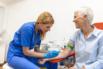 Preparation for blood test with senior woman by female doctor medical uniform on the table in white...