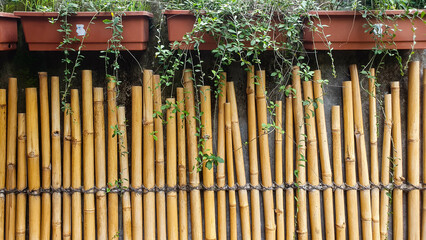 Crafted Elegance: Artful Arrangement of Bamboo into an Asian-inspired Fence