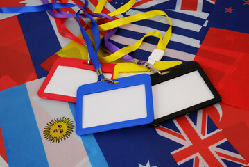 Colorful badges with strings on national flags background.  - obrazy, fototapety, plakaty