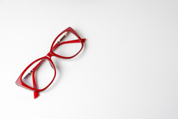 Women's glasses in red frames on a white background