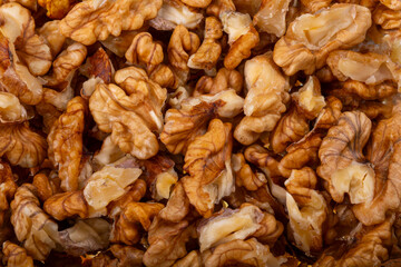 Walnuts on a black brown background.