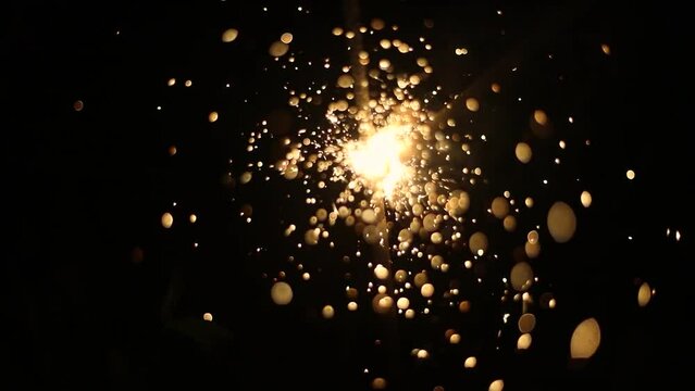 Burning sparklers. Details of the holiday. Sparks in the dark. Combustion of gunpowder.