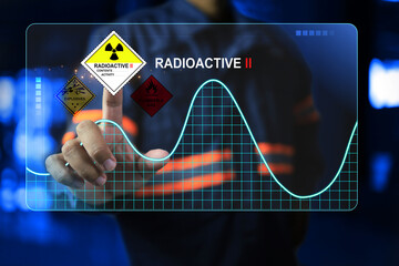 Engineer hand pointing on touchscreen with radioactive label dangerous goods standards symbol to warning hazard and danger symbolic radioactive material sign - obrazy, fototapety, plakaty