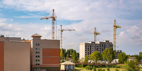 tower cranes on construction site, providing housing for low-income citizens of third world countries