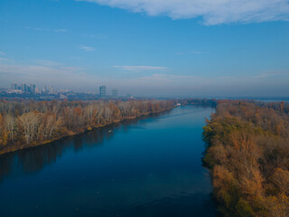 Obraz premium The rowing canal spit on Pobeda in the city of Dnieper from above. River View. Autumn colors. Drone photography.