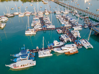 Aerial drone view of Chalong Pier in Phuket, Thailand. Many boats, yachts, sailboats and catamaran...
