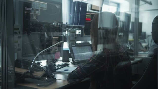 Navigation control room in the airport - a woman working with a monitor with air traffic