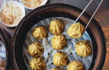 Fresh Dumplings with the Sticks in Traditional Chinese bamboo plate 