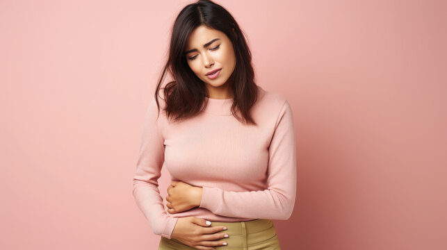 sad young woman holding her stomach, illness, cramps, health, color background, girl suffering, painful periods, stomach-ache, abdominal, griping, bellyache, tummy-ache, gripes, portrait, ill, pastel