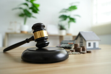 Judge Auctions and the Real Estate Legal System House model and hammer with icons on wooden table...
