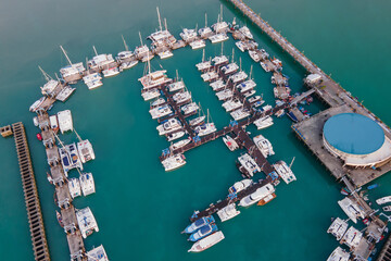 Aerial drone view of Chalong Pier in Phuket, Thailand. Many boats, yachts, sailboats and catamaran...