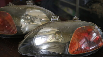 Two car lights were dirty, full of dust and mold.