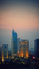 Fototapeta premium Jakarta, Indonesia – August 14, 2023: A sunset view cityscape of Indonesia capital city Jakarta