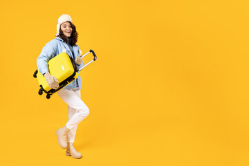 Fototapeta na wymiar A woman in a warm ski suit with a suitcase.