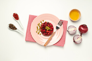 Salad vinaigrette, peppers, onion and oil in bowl on white background, top view