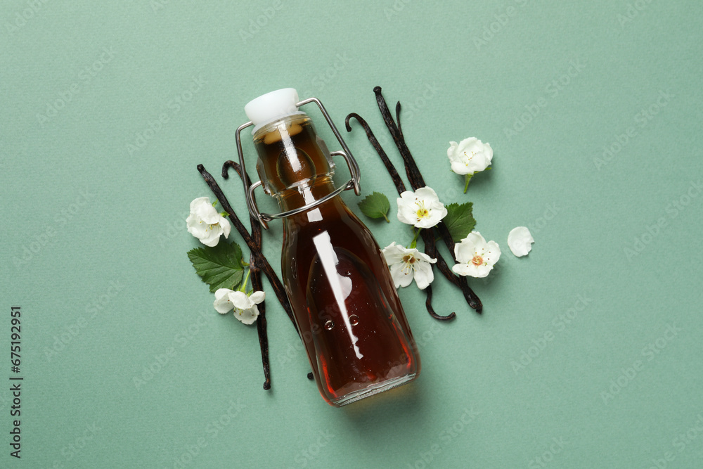 Wall mural Vanilla extract in a bottle on a light background