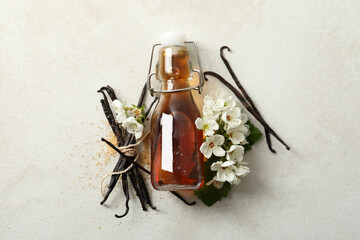 Vanilla extract in a bottle on a white background - obrazy, fototapety, plakaty