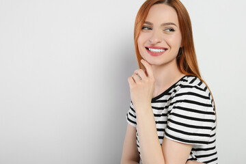 Obraz premium Portrait of beautiful young woman on light gray background, space for text