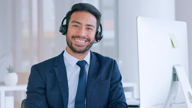Portrait of a salesman consulting and operating a helpdesk for customer sales and service support. Male call centre agent with a headset and computer, smiling and laughing while working in an office