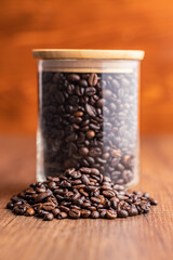 Roasted coffee beans on wooden table.