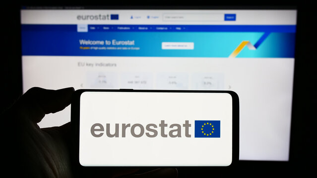 Stuttgart, Germany - 11-02-2023: Person holding cellphone with logo of EU institution European Statistical Office Eurostat in front of business webpage. Focus on phone display.