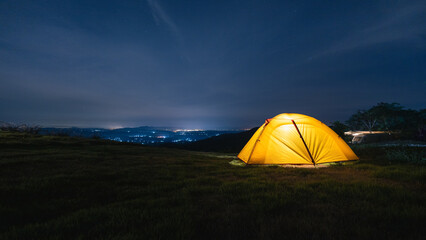 Fototapeta na wymiar Camping tent at night on the mountain top. Vacation, travel, adventure concept