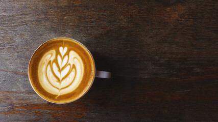 a cup of latte art coffee on wooden background                                                                                                                                                          