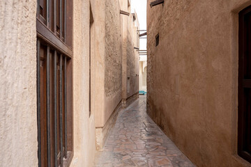Obraz premium View of narrow clean streets between traditional stone buildings in old city Souk Madinat Jumeirah, Al Fahidi, Dubai, UAE, United Arab Emirates 