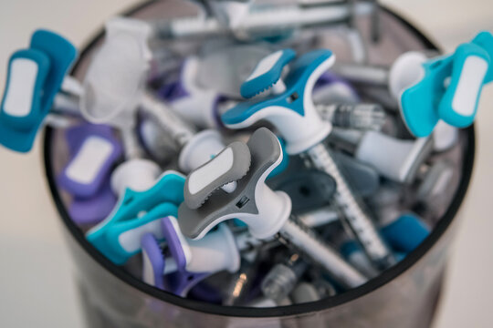 Collection of dermal beauty tuberculin syringes in a vase. Colorful filler syringes decorating aesthetic clinic or salon