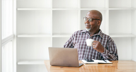 Portrait of black confident man at home. Portrait of a senior man relaxing during work at home.