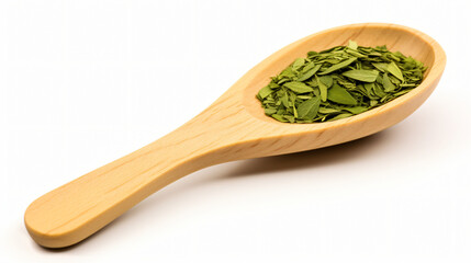 Aromatic green dry tea on a wooden spoon.