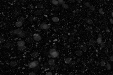 Flurry of snowflakes cascading through the air. Falling snow background.