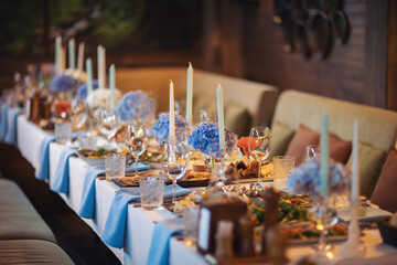 Beautiful decorated table set for wedding party. Wedding/Baby shower decorations with flowers. Background of decorated party table with selective focus. Decor and food on luxury celebration.
