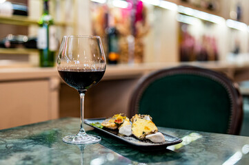tasting set appetizer food and red wine glass on table