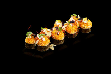 Set of baked sushi roll with shrimp and salmon on a black background. Japanese food, photo for menu