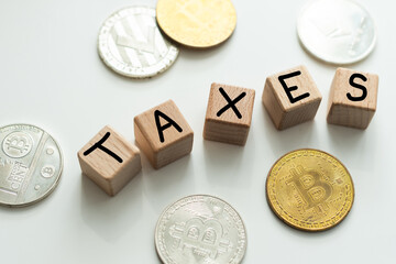 Alphabet TAXES and golden coins on table