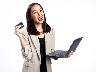 Naklejka premium A portrait of an Indonesian Asian woman wearing a cream-colored blazer, using a laptop, and showing a card. Isolated against a white background.