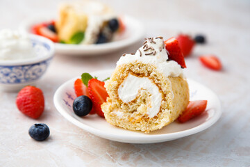 Homemade Swiss roll with whipped cream and berries