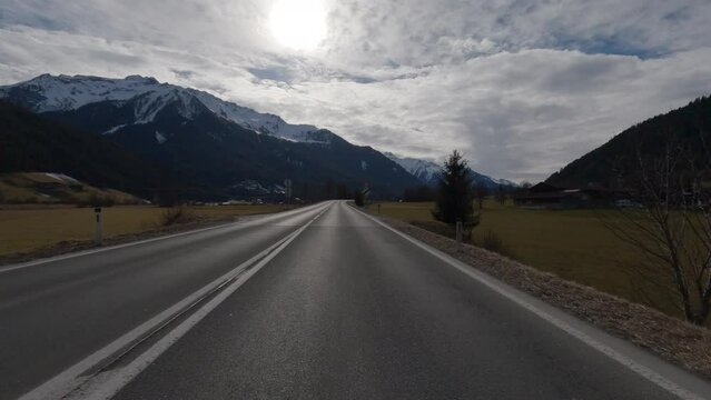 POV FRONT VIEW DRIVING PLATE car driving on winter roads in Austrian Alps