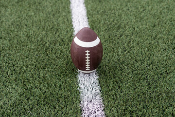 photo american football ball on stadium background