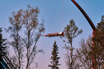 Extreme carousel in an amusement park . Attraction on the background of nature .
